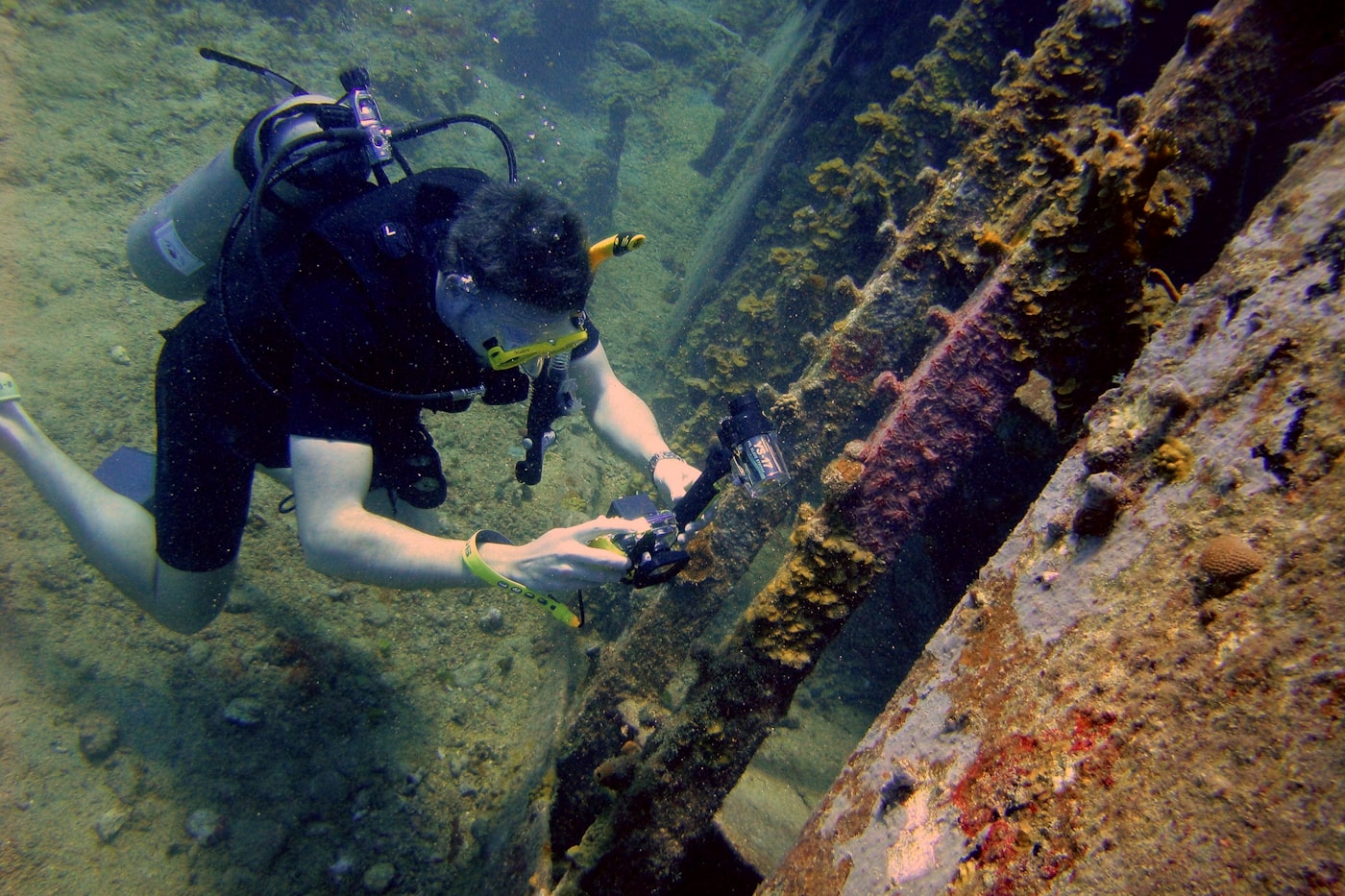 Scuba diver exploring an underwater shipwreck.